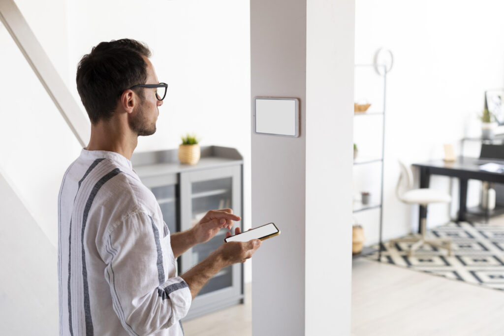 man-using-smartphone-his-automated-home (1)